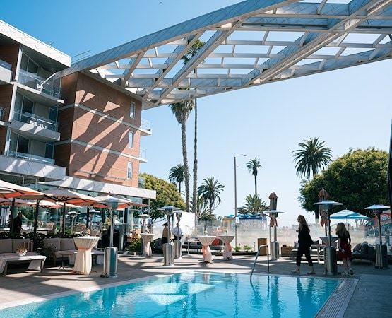 A pool with people standing around